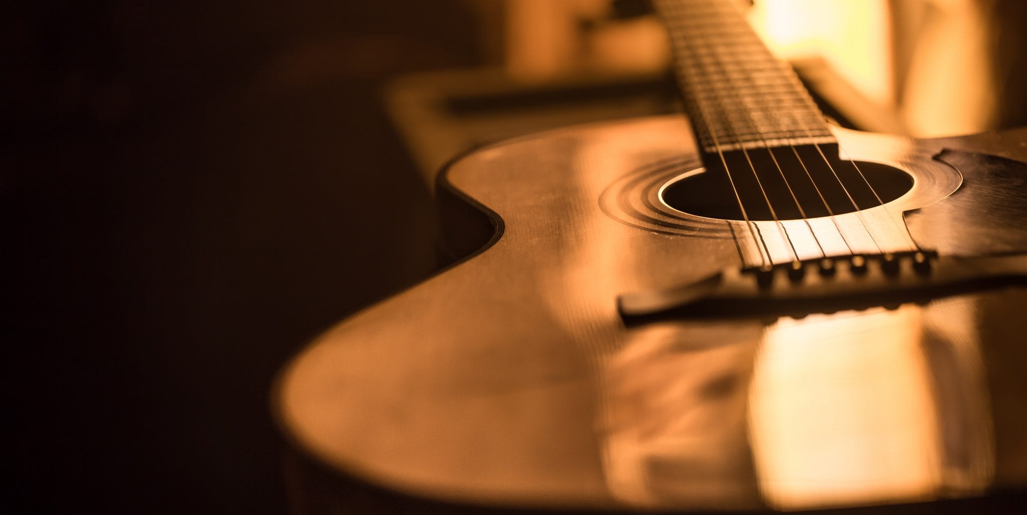 acoustic guitar close-up on a beautiful colored background acoustic guitar close-up on a beautiful colored background