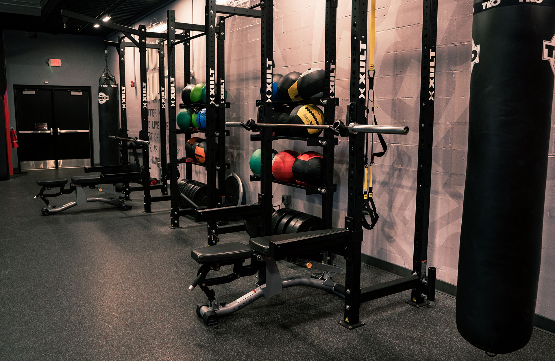 Bench press and squat rack machines at the 24/7 fitness center